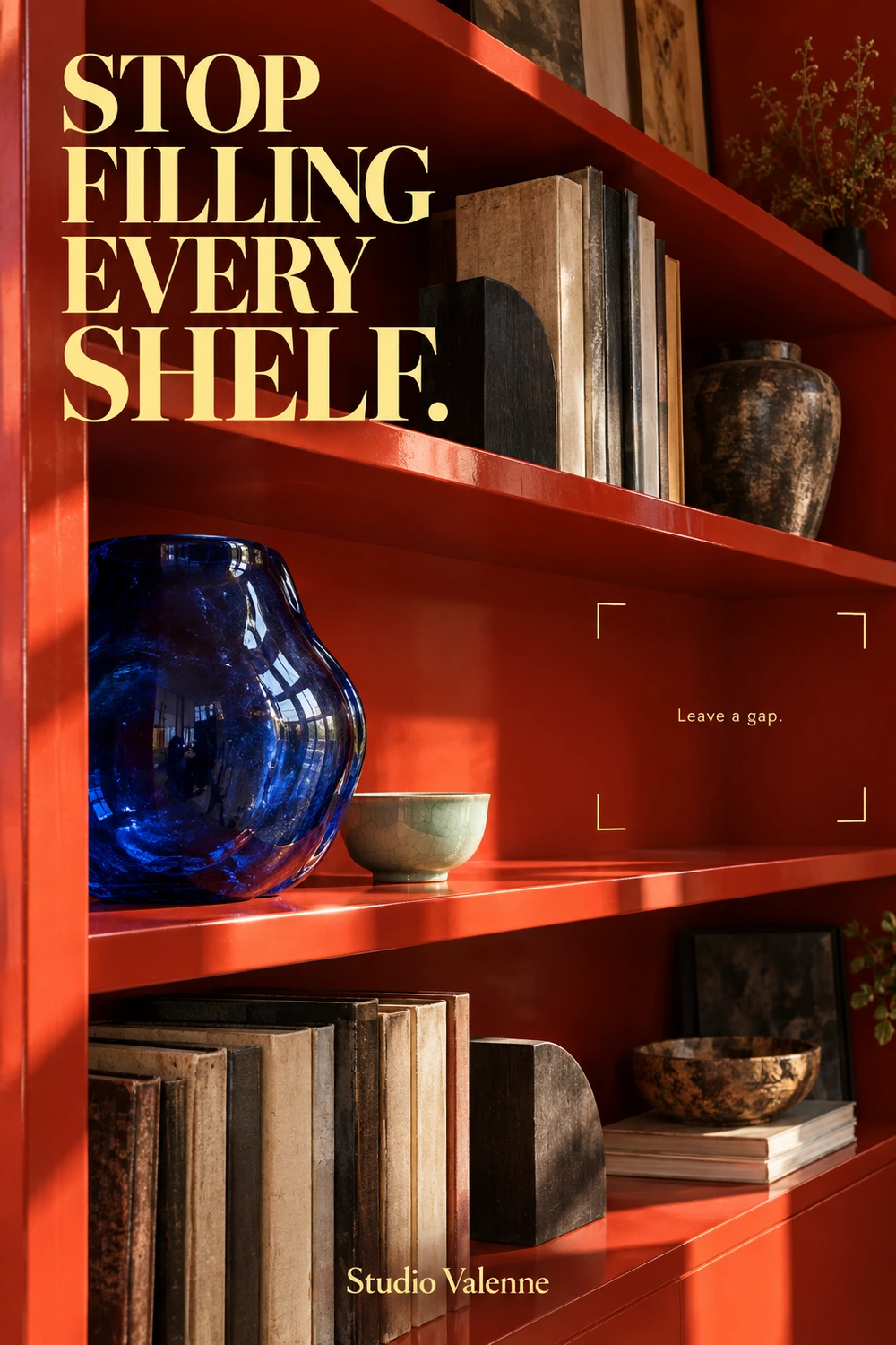 Red lacquer shelves with worn books, a cobalt glass vase and a pale green bowl. Butter-yellow brackets mark a clear area beside the objects.