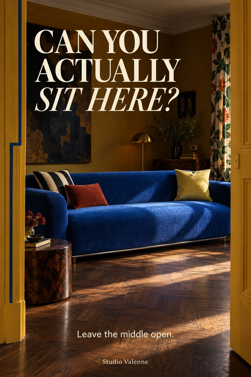 A cobalt sofa framed by an ochre doorway, with striped and rust cushions at one end, a pale yellow cushion at the other and an open center seat.