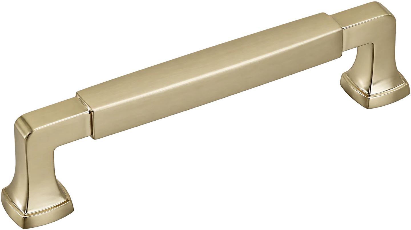 Cabinet drawer pull in golden champagne finish, shown at a three-quarter angle. Features a rectangular bar grip with squared, tapered base feet and a brushed satin gold-toned metal surface with subtle geometric detailing.