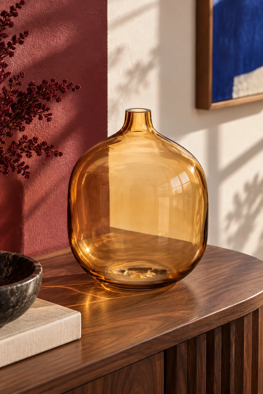 An amber glass bottle vase styled in a warm contemporary living room.