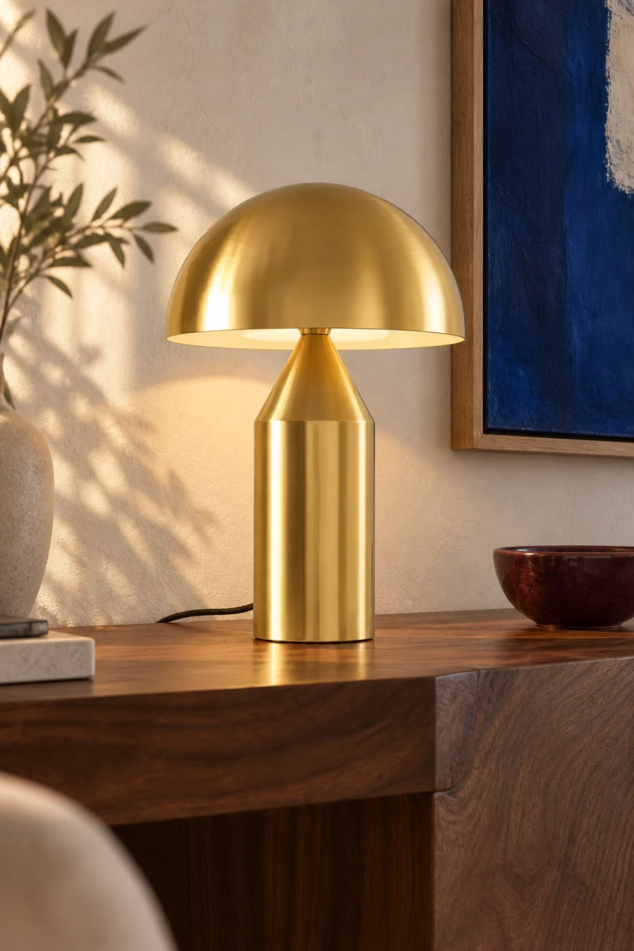 Brass-finish mushroom table lamp in a contemporary interior setting.