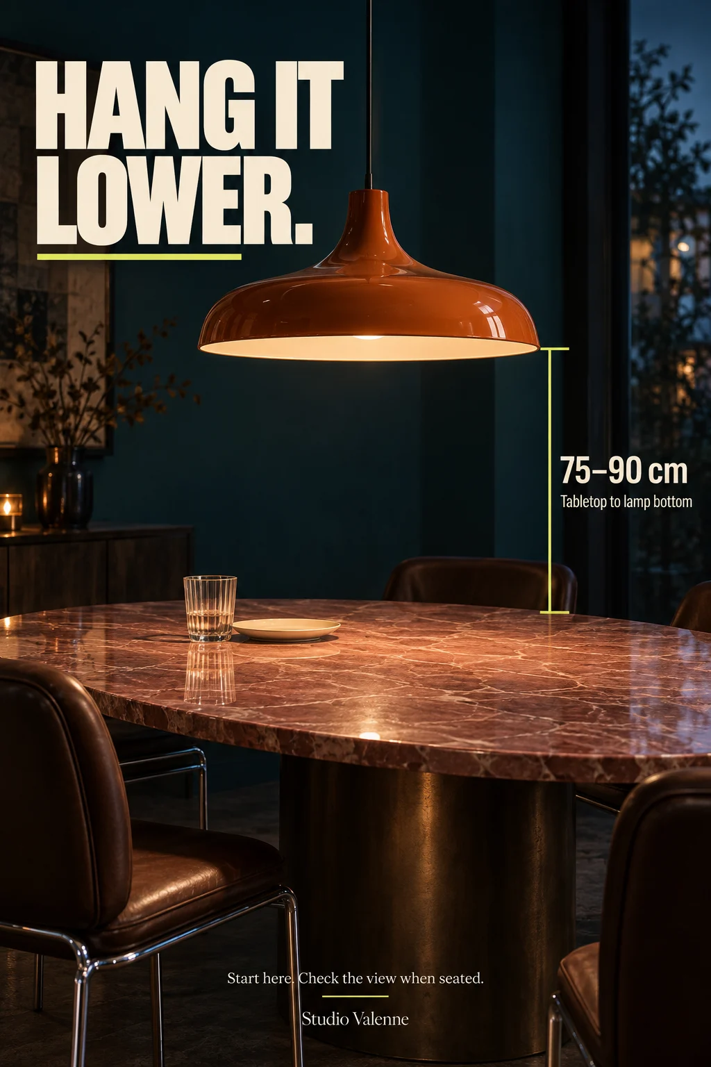 An orange pendant above a pink stone table with a tabletop-to-lamp height marker.